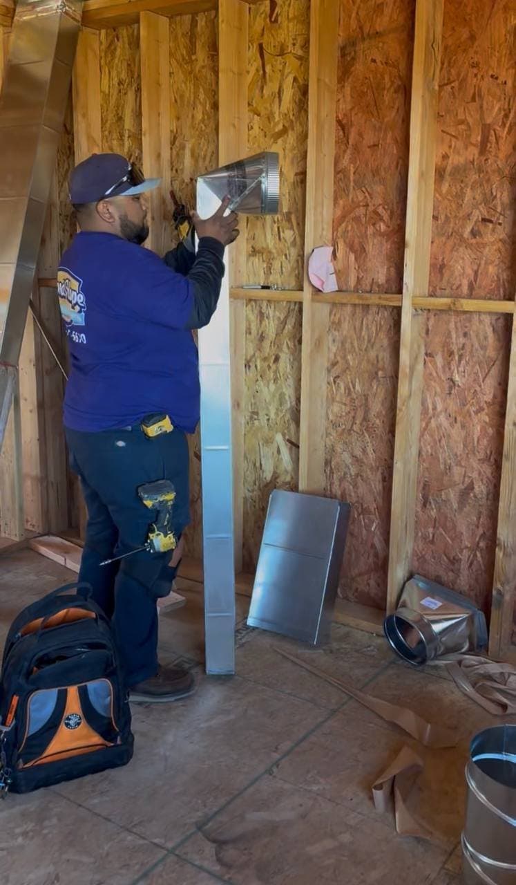 A Good Hope technician installing ductwork